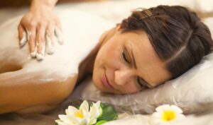 A woman is enjoying body wrap.