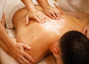 A man is enjoying four hands massage.