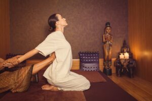 A woman is enjoying Thai massage.