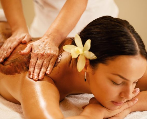 A woman is enjoying body scrub.