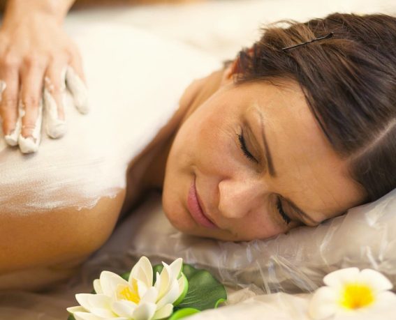 A woman is enjoying body wrap.