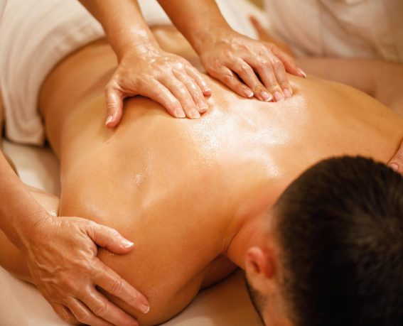 A man is enjoying four hands massage.