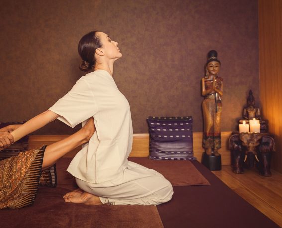 A woman is enjoying Thai massage.